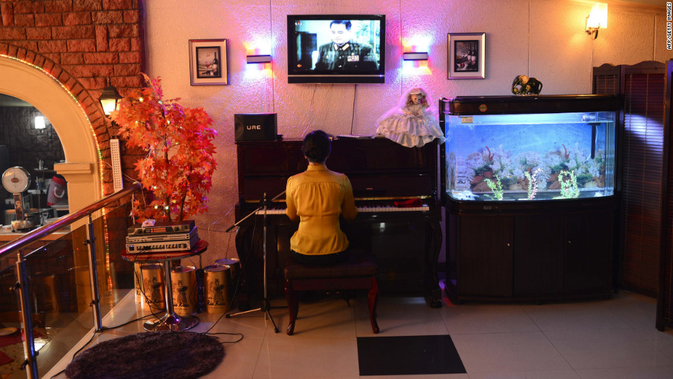 A woman plays the piano and entertains in a downtown Pyongyang restaurant. U.S. President Obama said the real consequence for North Korea, should it go through with the launch, is that the country&#39;s leaders will miss an opportunity. &quot;I hope that at some point the North Koreans make the decision that it is in their interests to figure out how to feed their people and improve their economy rather than have big parades where they show off weapons,&quot; he said in March.