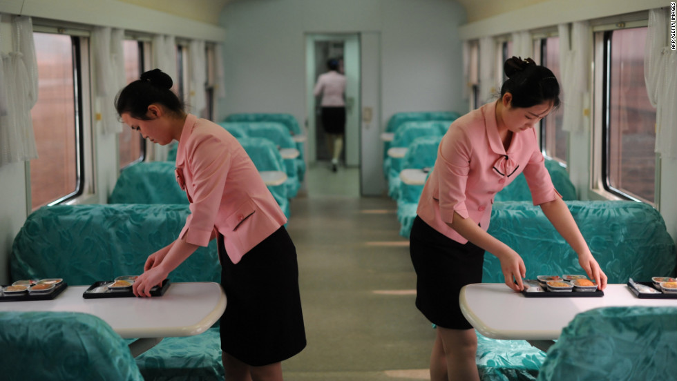 Two women on the the train prepare food for the journalists traveling across the country.