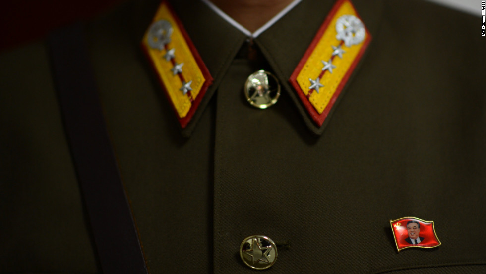 A pin with the face of Kim Il-Sung is affixed to the uniform of a North Korean soldier standing guard at the space center in Pyongyang on Wednesday, April 11.