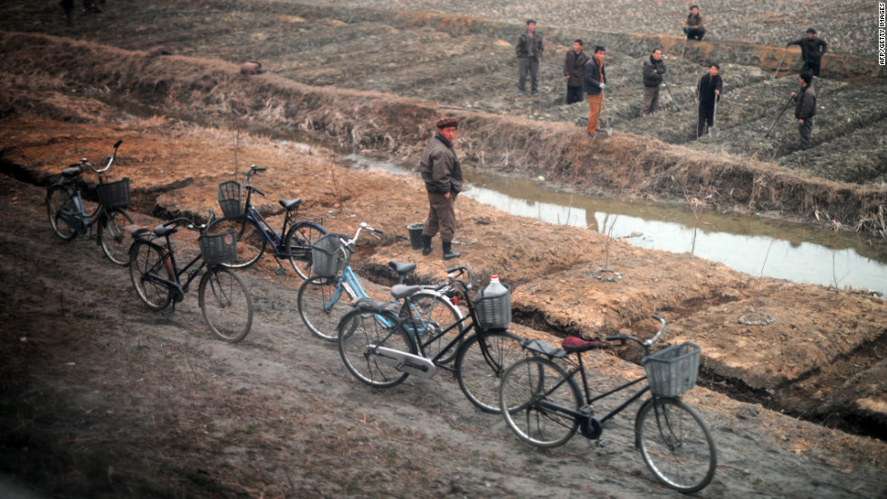 Bicycles line the road as citizens work the land between Pyongyang and the North Phyongan province.