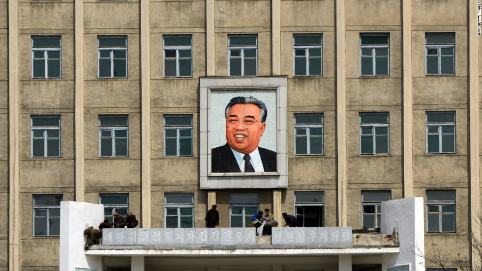 A building adorned with a huge portrait of the late president Kim Il-Sung is cleaned by workers in Pyongyang.