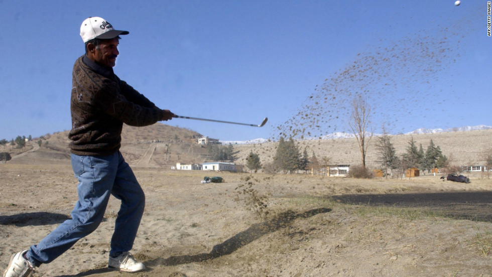 An Afghan player takes a swing during a tournament at the Kabul Golf Club. The nine-hole course, which first opened in 1967, became a battlefield in the 1990s when rival Mujahideen factions fought among themselves after overthrowing a Soviet-backed regime. 