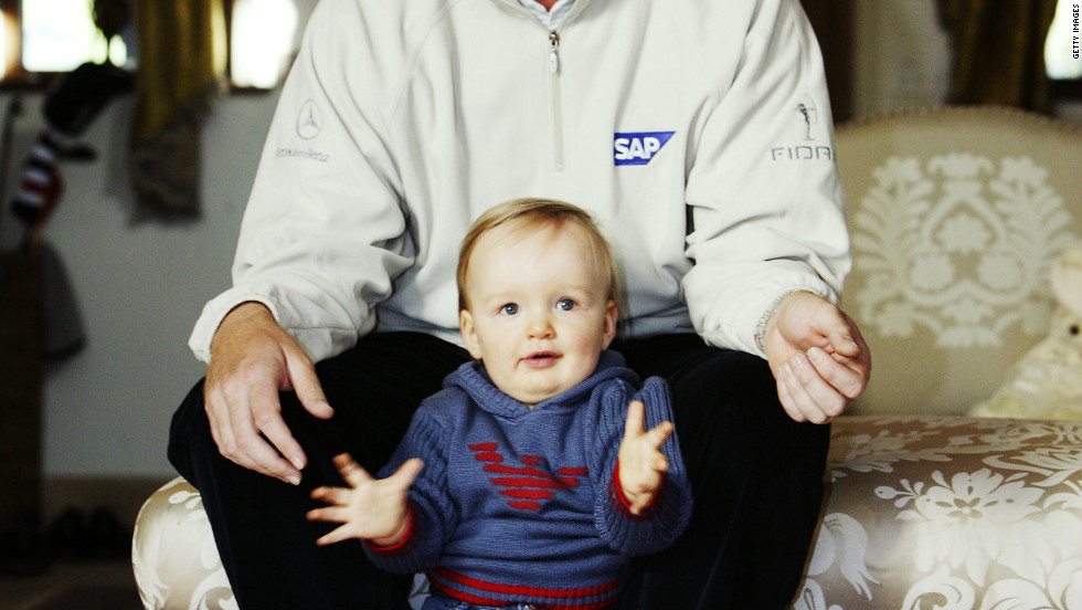 Now nine, the youngster still struggles to speak and attends a specialist school in Florida. He is pictured here with his father in their former home in England in 2003.