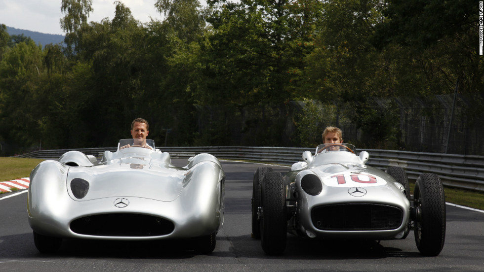 Michael Schumacher in the modern Silver Arrow while Mercedes teammate Nico Rosberg takes the wheel of the 1955 model. 