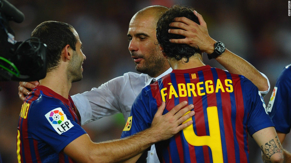 Guardiola congratulates Barca players Cesc Fabregas and Javier Mascherano after winning the Spanish Supercup against Real Madrid at the start of the 2011-12 season.