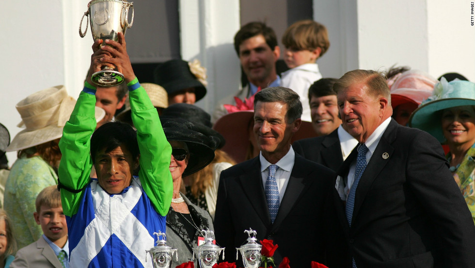 Matz looks on as jockey Edgar Prado celebrates Barbaro&#39;s commanding seven-length victory.