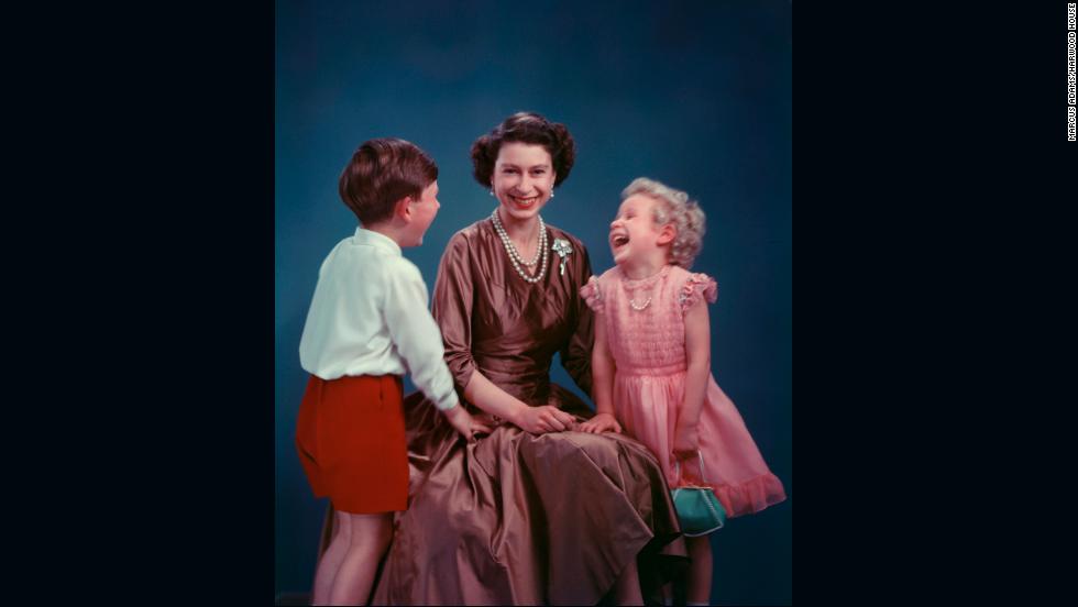 From the Royal Collection -- the queen sits for a photograph with a young Prince Charles and a very blonde Princess Anne.