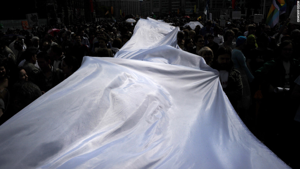 Demonstrators carry a giant white ribbon as they march on Sunday. In Russia, the white ribbon has emerged as a symbol of the opposition movement.