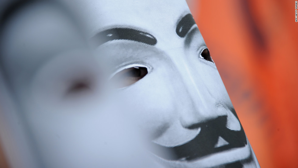 A protester wears a Guy Fawkes mask Sunday.