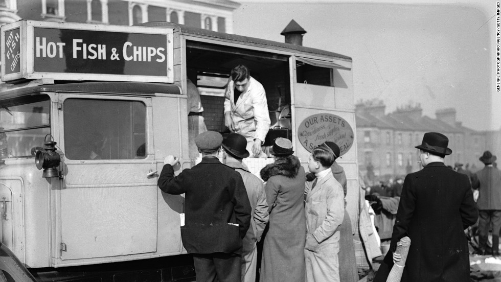Customers circa 1935 queue at a van at Caledonian Market, London. Britons have been enjoying fish and chips for an estimated 150 years.