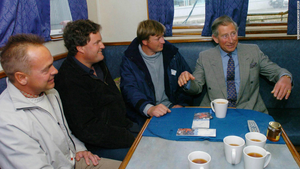 A former Royal Navy officer, the Prince of Wales has long taken an interest in sustainable fishing. Here, he has a cup of tea with fishing boat skippers in Plymouth Harbour, while launching a regionable initiative in 2004.