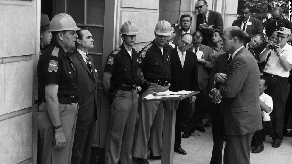 Federal Deputy Attorney General Nicholas Katzenbach, standing on the right, confronts Alabama Gov. George Wallace at the University of Alabama in Tuscaloosa on June 11, 1963. Wallace is standing in the doorway to prevent two African-American students from entering despite a presidential order. Wallace, who was pro-segregation, later stood aside.