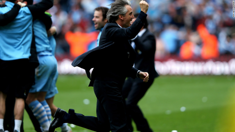 City manager Roberto Mancini (center) runs to greet his jubilant players after their breathtaking victory.