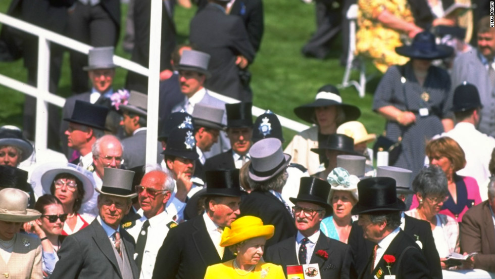Her Majesty pictured with race goers during the Ever Ready Derby at Epsom racecourse in Epsom, England. It is said in racing circles that the British sovereign&#39;s reading material of choice over her breakfast is the Racing Post.