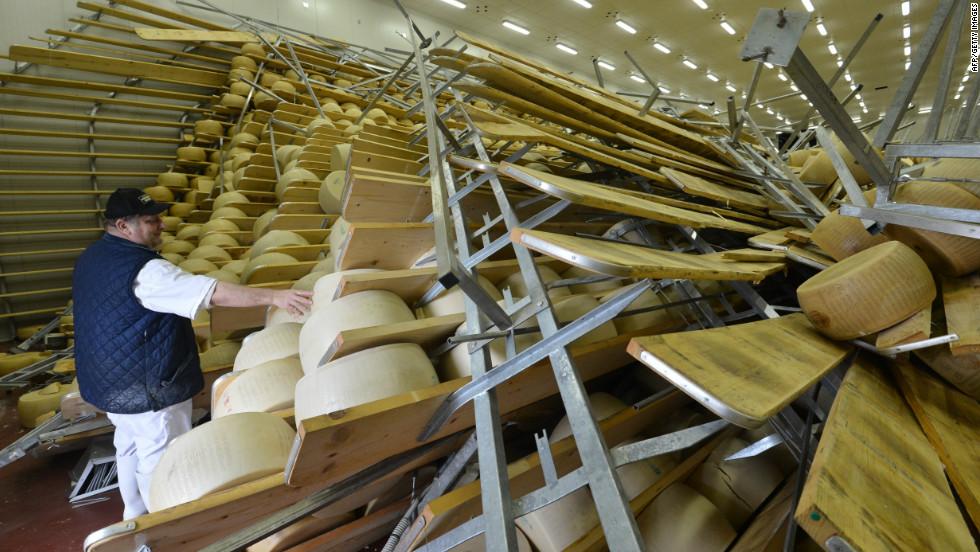 Hundreds of blocks of cheese fell on top of one another at a parmigiano factory in San Giovanni, Parsiceto. The owner of the factory surveys the damage on May 21, 2012, following an earlier quake.