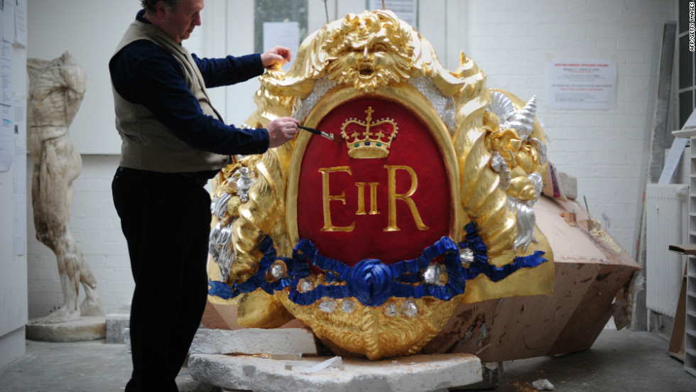Head of Historic Carving Alan Lamb, poses next to the royal cypher that will decorate the Royal Barge in which the queen will travel along the Thames during the river pageant on June 3. 