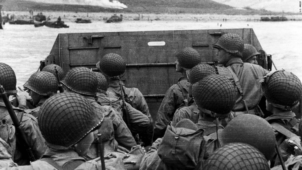 US troops huddle behind the protective front of their landing craft as it nears a beachhead in France. Smoke in the background is naval gunfire giving cover to troops on land. Germans rained mortars and artillery down on Allied troops, killing many before they could even get out of their boats. Fighting was especially fierce at Omaha Beach, where Nazi fighters nearly wiped out the first wave of invading forces and left the survivors struggling for cover.