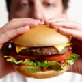 Man eating hamburger close-up