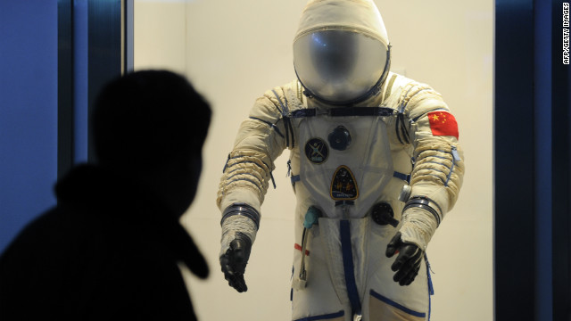 A visitor at the Shanghai Science &amp; Technology Museum looks at a spacesuit used by Chinese astronauts.