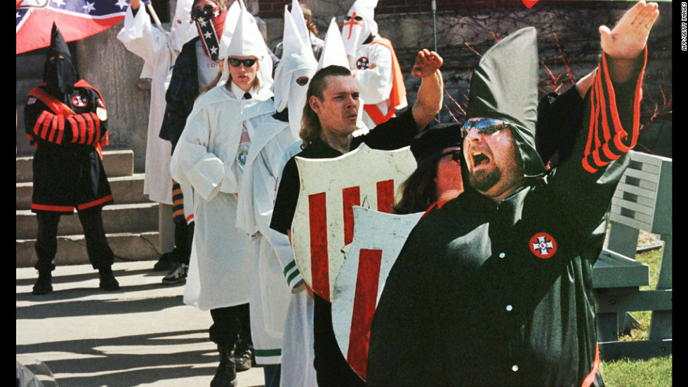 Ku Klux Klan members chant &quot;white power&quot; during a rally to recruit members on the steps of the Defiance, Ohio, courthouse in 1999.