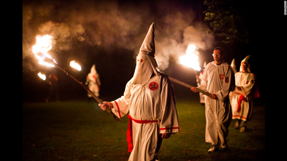 Members of the Knights of the Southern Cross of the Ku Klux Klan, joined by members of other Virginia Klan orders, participate in a cross lighting ceremony on May 28, 2011, near Powhatan, Virginia.