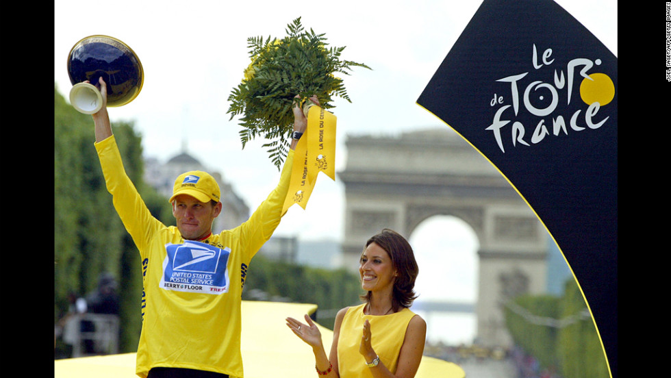 Armstrong celebrates on the podium after winning the Tour de France by 61 seconds in 2003.