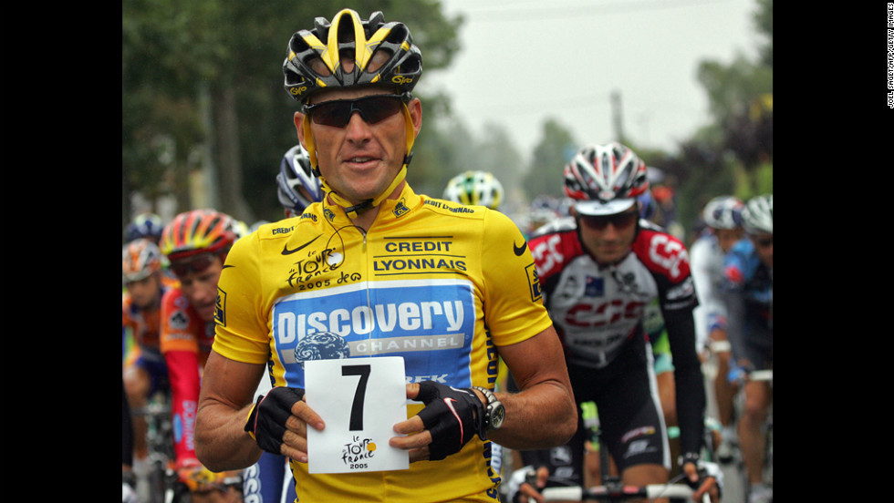 Armstrong holds up a paper displaying the number seven at the start of the Tour de France in 2005. He went on to win his seventh consecutive Tour de France.