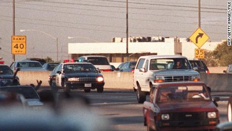 Police cars pursue the white Ford Bronco driven by Al Cowlings, carrying O.J. Simpson on June 17, 1994 on the 405 freeway in Los Angeles. 
