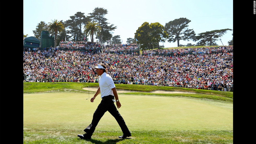Phil Mickelson walks off the eighth green.