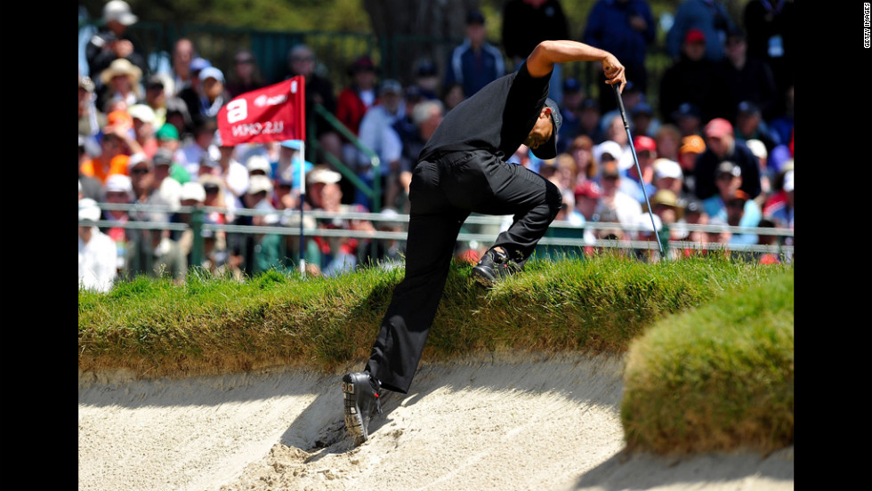 Tiger Woods climbs out of a bunker on the sixth hole during the second round.