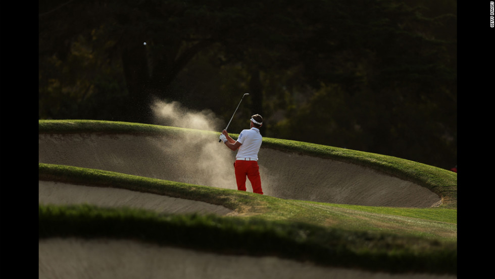 Raphael Jacquelin of France hits a bunker shot on the 17th hole during the third round.