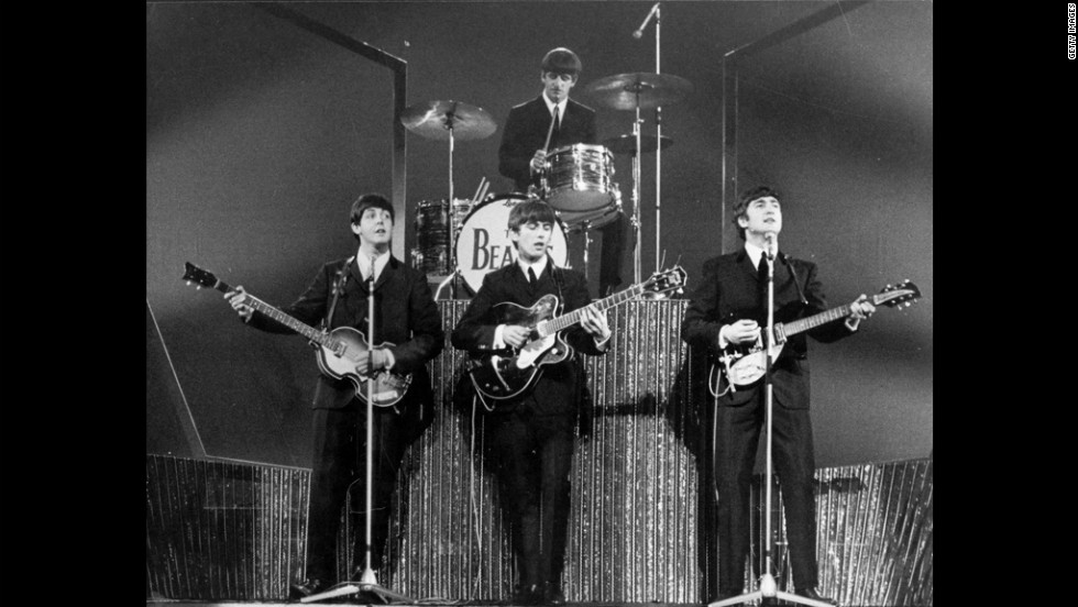 The Beatles, whose arrival in the U.S. in 1964 set off &quot;Beatlemania,&quot; perform on stage at the London Palladium in 1963.