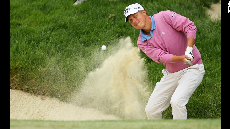 Fredrik Jacobson of Sweden plays a bunker shot on the second hole.