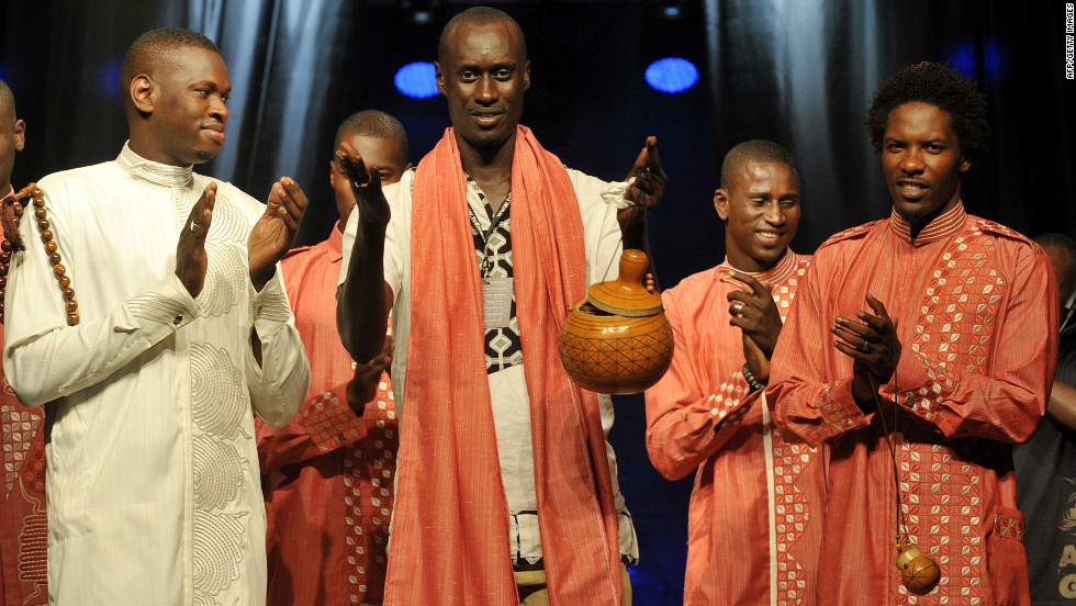 Senegalese designer Amdou Diop, center, thanks the crowd following his show.  