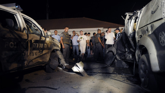 The remains of a rocket launched from Gaza are embedded in the ground Tuesday near the kibbutz of Yad Mordechay.