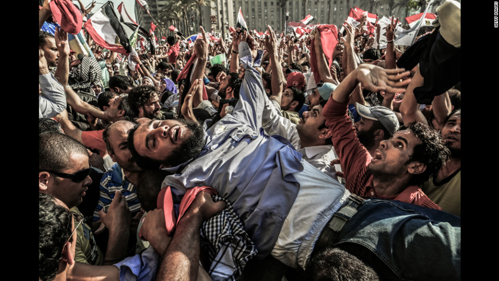 A supporter of the Muslim Brotherhood is carried away from the tightly packed arena of Tahrir Square in Cairo on Sunday as Mohamed Morsi supporters celebrate his victory in Egypt&#39;s presidential election.