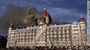 This photograph taken on November 27, 2008, shows Indian firefighters attempting to put out a fire as smoke billows out of the historic Taj Mahal Hotel in Mumbai, one of the sites of attacks by militant gunmen.