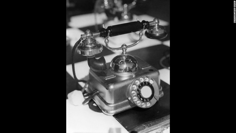 This 1950s rotary phone features an attached mouthpiece and receiver.