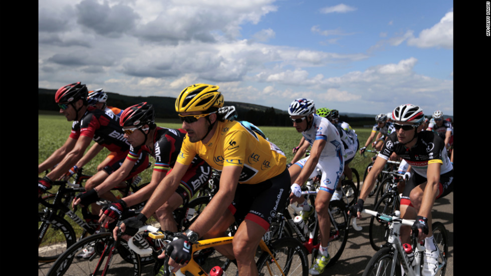 Cancellara, wearing the yellow jersey, rides alongside Cadel Evans of Australia, second from left, and Frank Schleck of Luxembourg, left, on Sunday.