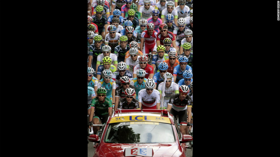 The peloton follows the official Tour de France vehicle at the beginning of Sunday&#39;s Stage 1.