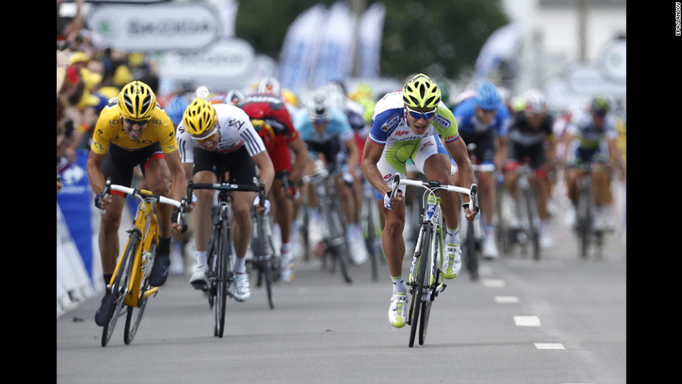 Peter Sagan of Slovakia, right, sprints to victory at the Stage 1 finish line Sunday ahead of Fabian Cancellara of Switzerland, left, and Edvald Boasson Hagen of Norway, center.