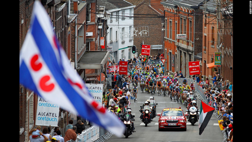 The peloton begins the final climb of Sunday&#39;s stage, called the Cote de Seraing, as riders near the finish of the 198-kilometer (123-mile) course.