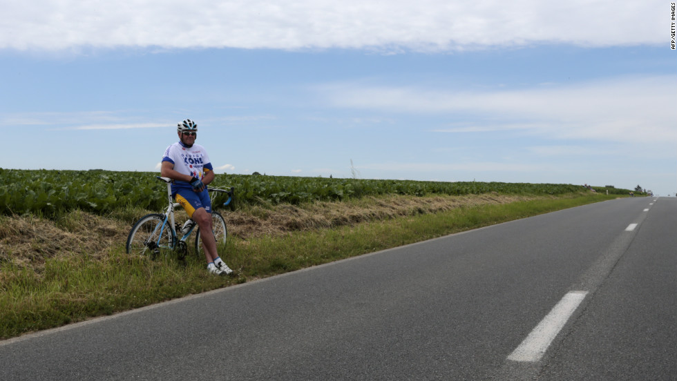 A spectator sits along the course Monday in Belgium, where Stage 2 of the race covers 129 miles from Vise to Tournai and is relatively flat.