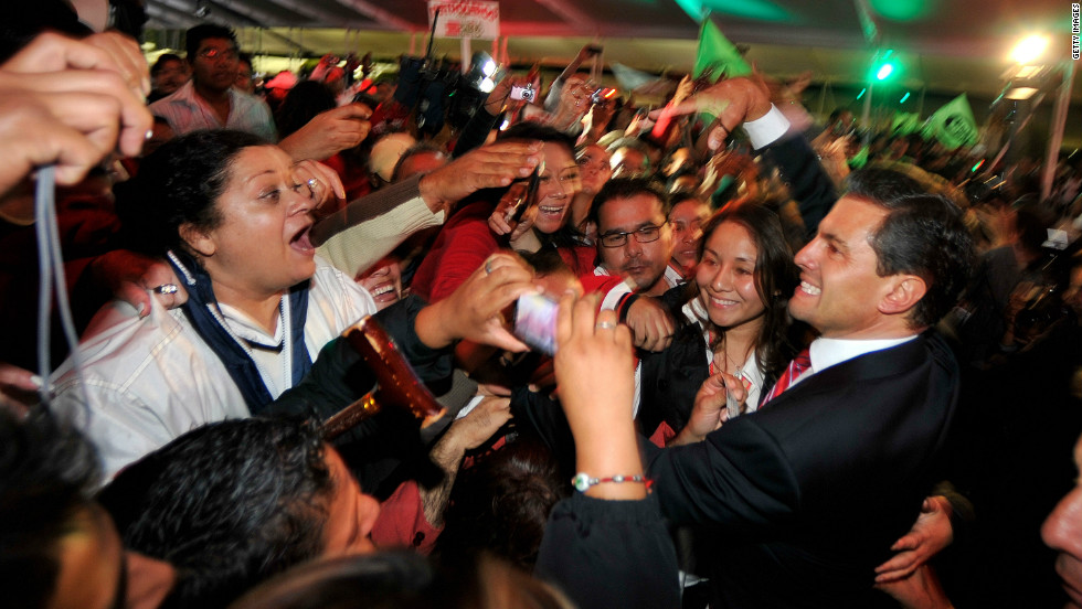 Peña Nieto greets supporters in Mexico City after polls closed and results stacked in his favor early Monday, July 2.