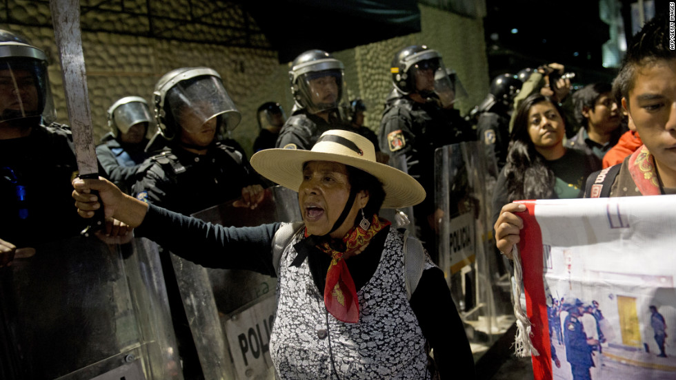 Supporters of the Mexican university student movement &quot;I Am 132&quot; protest in front of police outside the national TV network Televisa during a rally against the PRI and Peña Nieto in Mexico City on Saturday.