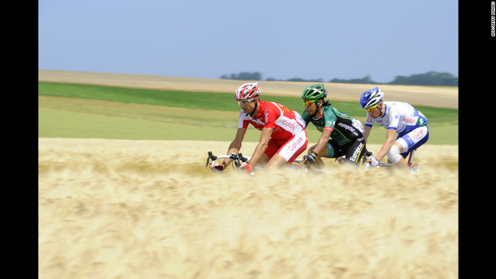 France&#39;s David Moncoutie, Japan&#39;s Yukiya Arashiro, and France&#39;s Anthony Delaplace ride in a breakaway.  