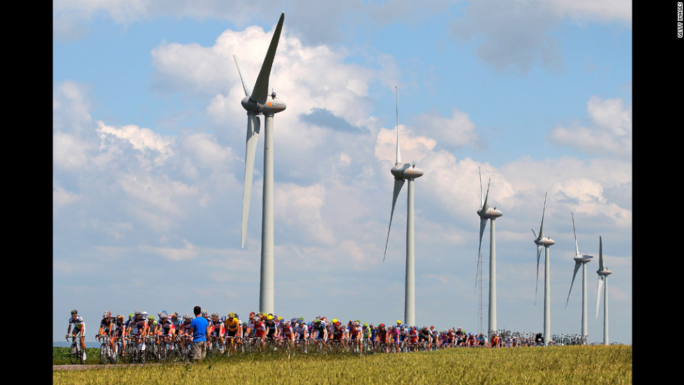 The peloton passes by windmills on Wednesday.