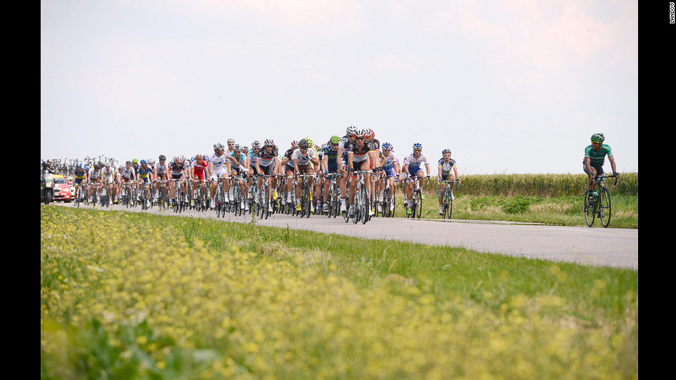 The pack of cyclists streams along a country road during Stage 4.