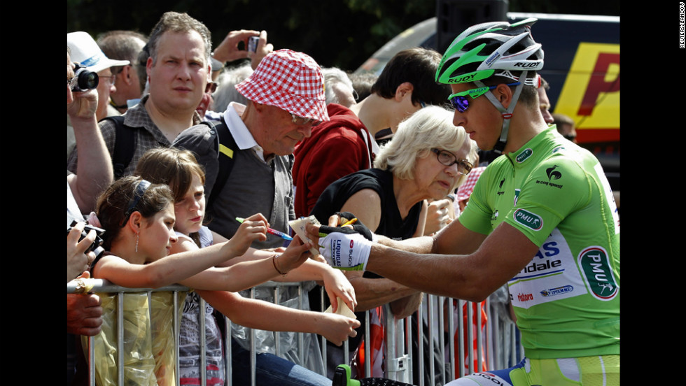 Liquigas-Cannondale rider Peter Sagan of Slovakia signs autographs for spectators.