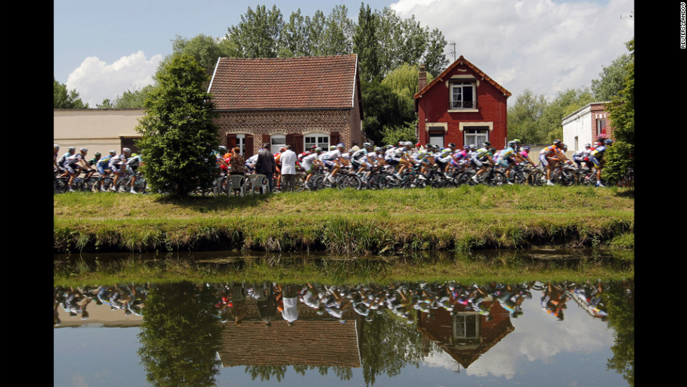 The pack of riders cycle through the city of Abbeville.